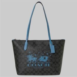 COACH Zip Top Tote In Signature
Canvas With Horse And Sleigh CN 626